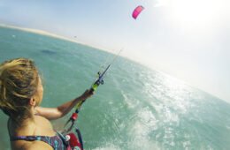 Miriam, the blogger of wake up stoked, kitesurfing on the water.